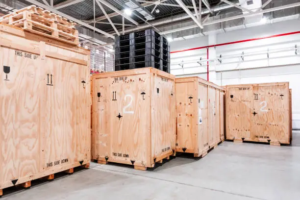 Wooden boxes in the warehouse. Boxes out of wood for packing industrial machinery. Warehousing. Packaging of finished products of the plant. Sale of packaging materials. packed products are ready for shipment
