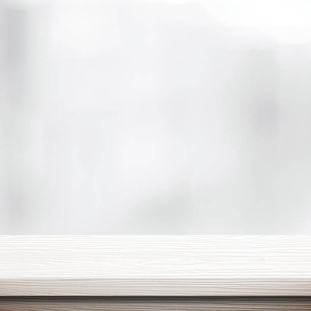 istock White table presentation, desk and blur background, Empty wood counter, shelf surface over blur restaurant white bokeh background, Wood table top for retail shop, store product display banner, mock up 1268172238