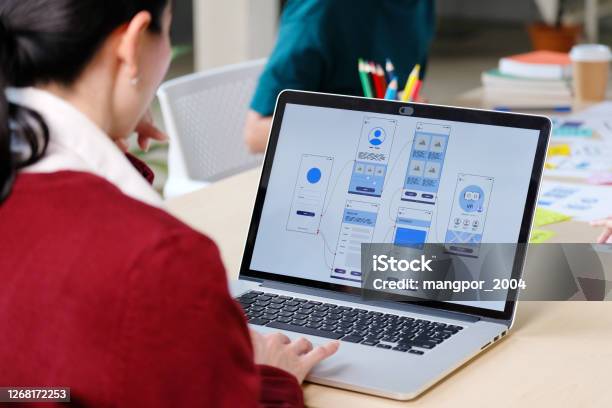 Website Designer Creative Planning Phone App Development Template Layout Framework Wireframe Design User Experience Concept Young Asian Woman Ux Designer Working On Smartphone Application At Office Stock Photo - Download Image Now