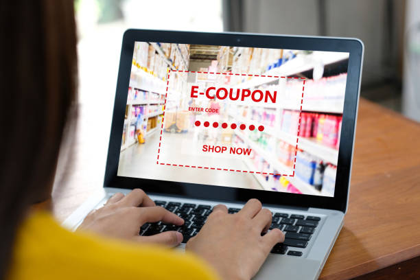 istock E-coupon, Grocery shopping online, Woman hand using laptop computer with discount coupon on screen, online shopping sale, digital marketing, retail business and technology, e commerce promotion concept 1268172321