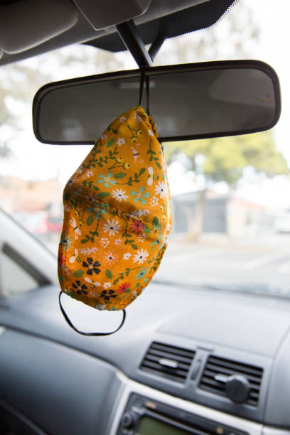 istock Floral Patterned Face Mask Hanging from the Rear View Mirror 1268174500