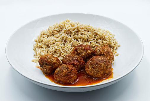 Meatballs with basmati rice on white dish isolated on white