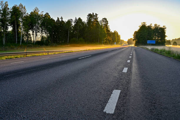 istock early sunrise over straight road with deminishing perspctive 1268184708