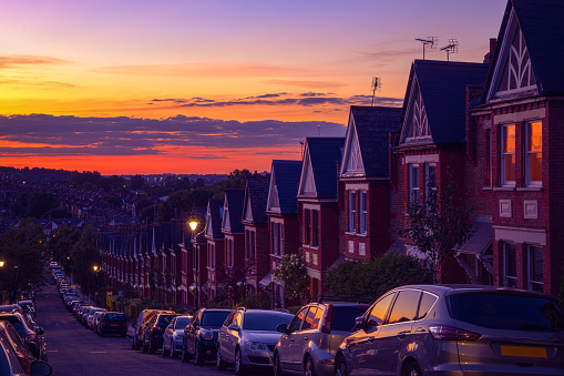 Row of identical English terraced houses at sunset in Crouch End, North London