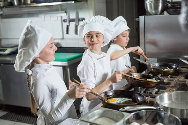 istock Children cook eggs in the kitchen at the Restaurant. 1268186442