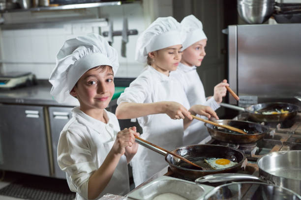 istock Children cook eggs in the kitchen at the Restaurant. 1268186457