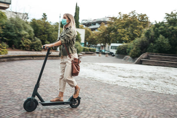 istock Green mobility in the city; woman commuting to work 1268186696