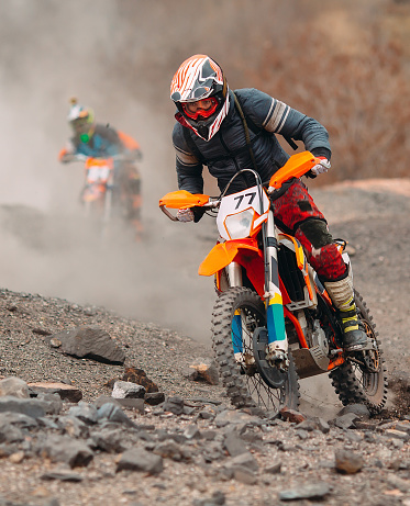 View of a dirtbike on the dirt road up to hill.