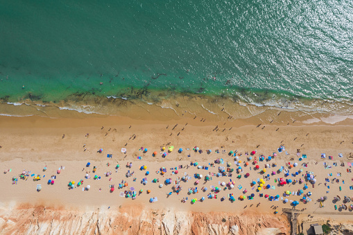 Top view shot with drone from beach in Portugal, crowds of people