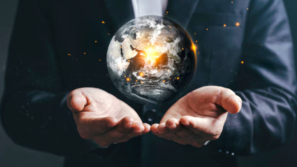 地球の一日の再生の地球温暖化範囲における省エネと環境資源の保全をコンセプトとする地球 - globe human hand holding concepts ストックフォトと画像