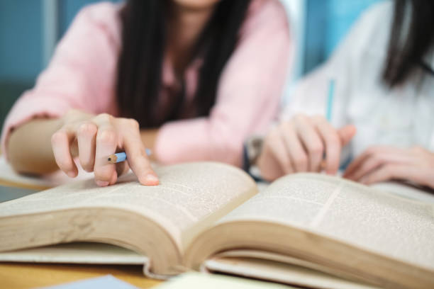 istock Young students campus helps friend catching up and learning. 1268193326