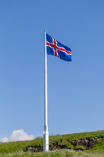 United Kingdom flag waving in the wind on a clear day. Union Jack. Blue field with red, white crosses of patron saints. Rippled fabric. Realistic 3d illustration