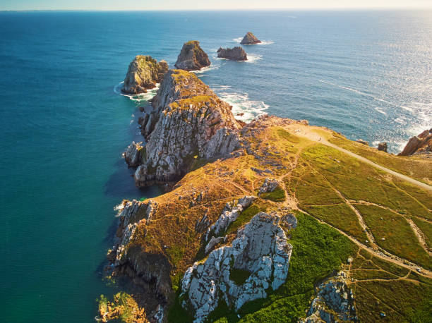 Scenic view of Crozon peninsula, one of the most popular tourist destinations in Brittany, France Scenic view of Crozon peninsula, one of the most popular tourist destinations in Brittany, France. Aerial drone view of widely known tourist attraction along famous GR34 tracking path peninsula stock pictures, royalty-free photos & images