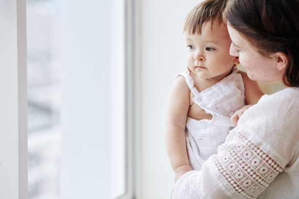 istock Mother carrying daughter 1268197422