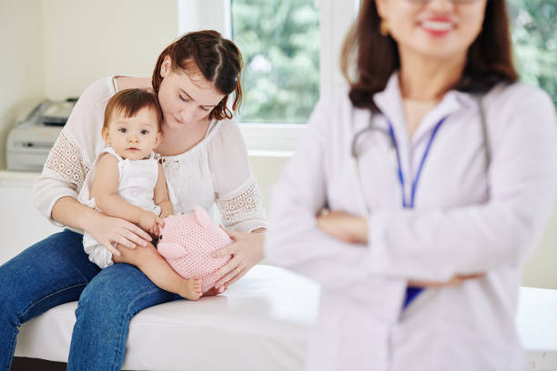 istock Mother and daughter at doctors office 1268197430