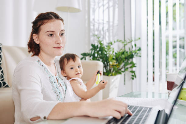 istock Young mother working on laptop 1268197455