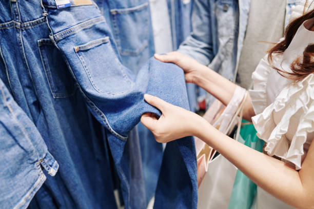 istock Woman choosing jeans in store 1268200022