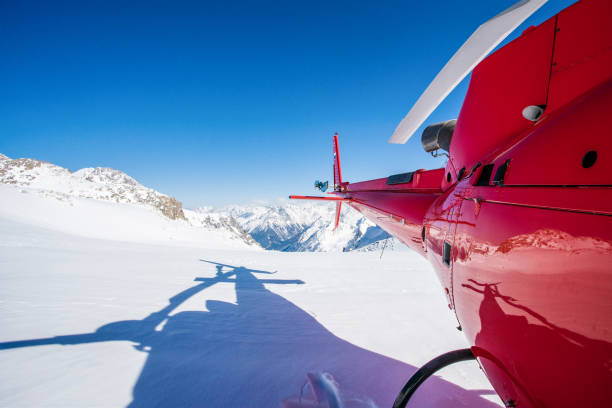 istock Red commercial helicopter in the mountains 1268200300