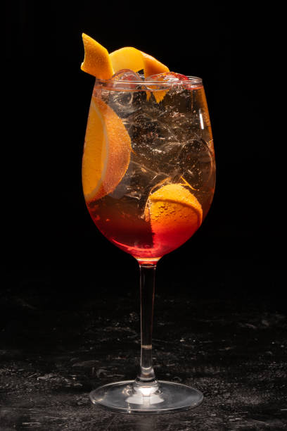istock Alcoholic cocktail in a transparent glass goblet on a black background. 1268200732