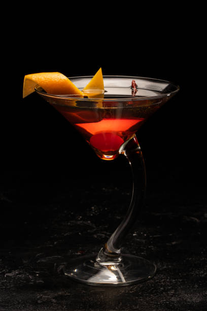 istock Alcoholic cocktail in a transparent glass goblet on a black background. 1268200735