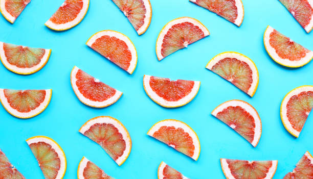 istock High vitamin C. Juicy grapefruit slices on blue background. 1268200791