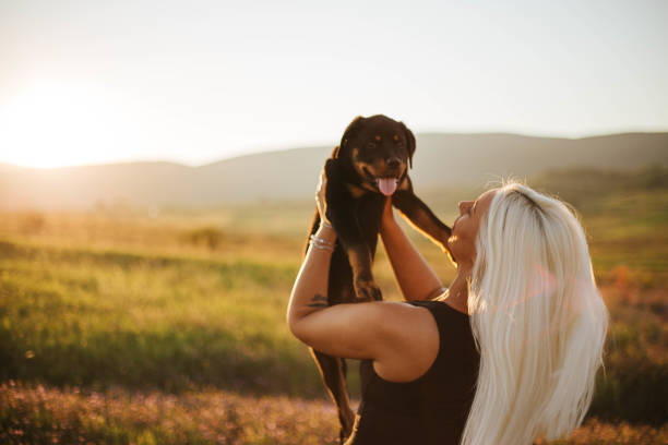 Beautiful blonde enjoys a sunny day with her dog