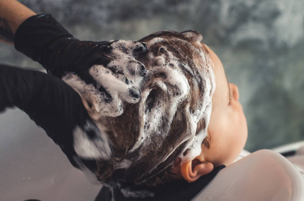 istock hands washing a child's hair 1268203454