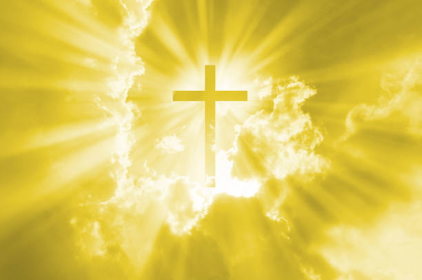 istock Christian cross appears bright in the gold sky 1268206588