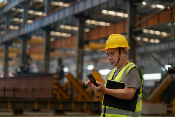 istock Male employee using mobile phone in factory 1268208015