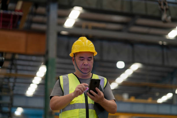 istock Male administrator using mobile phone in factory 1268208021