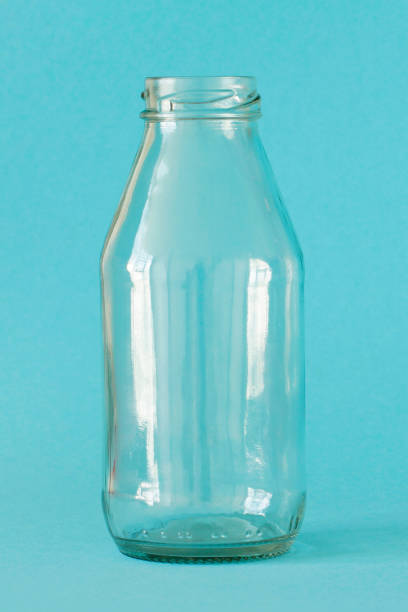 istock Empty milk bottle isolated on blue background, front view. Close up. Concept - Plastic free 1268214341