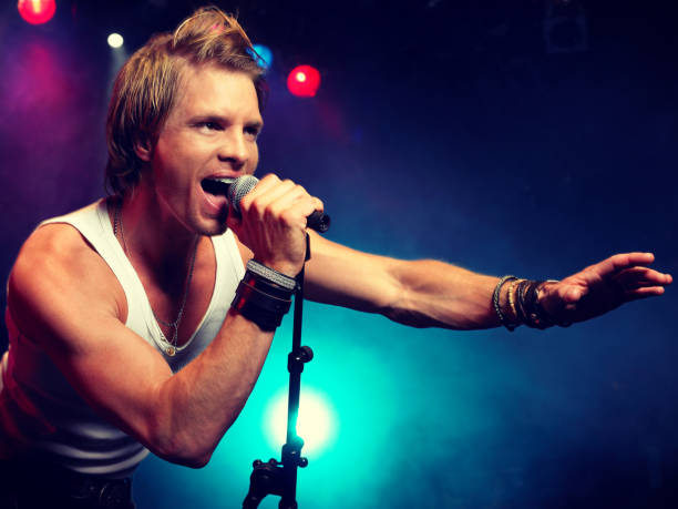 istock Young Man Singing at rock Concert 1268215011