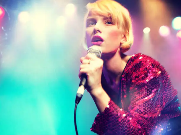 Photo of Young female rockstar Singing in Concert