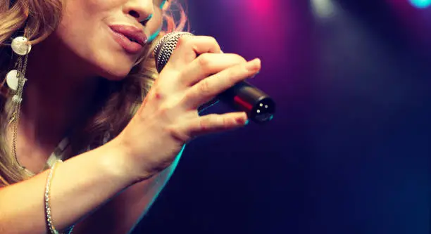 Photo of Young female rockstar Singing in Concert