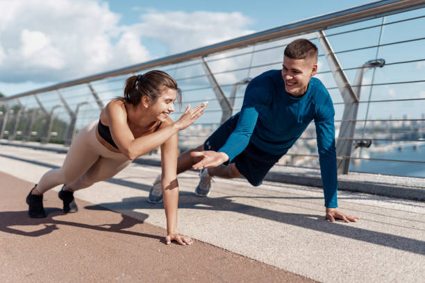 istock Man and woman making sport training outdoors together 1268216232