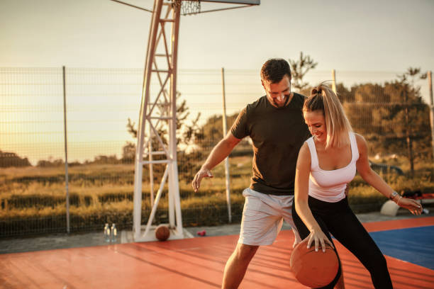 istock Young happy couple playing basketball 1268217908