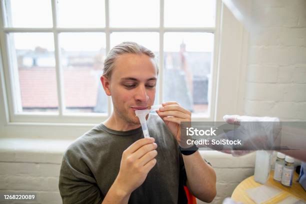 Collecting Saliva Stock Photo - Download Image Now - Saliva - Bodily Fluid, Scientific Experiment, Medical Test