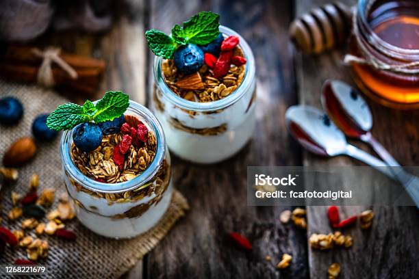 Healthy Eating Yogurt With Granola And Berries Stock Photo - Download Image Now - Yogurt, Parfait, Blueberry