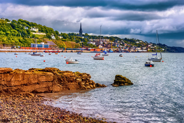 Cork Harbour in Ireland with sailboats and boats and town of Cobh skyline
