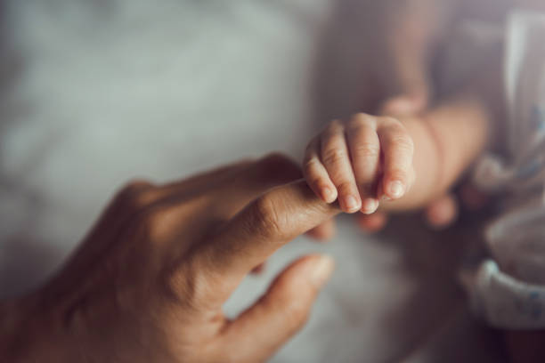 istock Newborn baby holding mother's hand. 1268226942