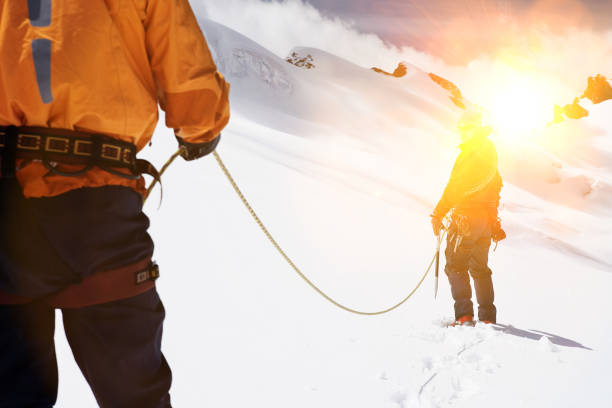 istock Two mountaineers hiking in mountains holding ropes 1268227171