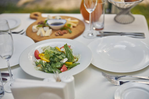 istock White plate with green salad for the diner 1268232703