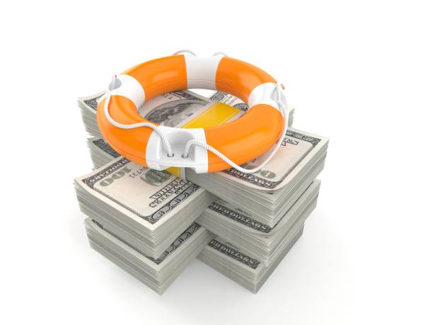 istock Life buoy on stack of money 1268233305