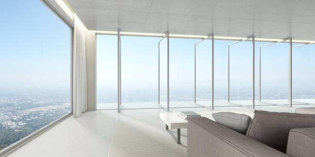 istock 3d render of large windows panel and terrace on city background, Modern living room with sofa and concrete floor. 1268234026