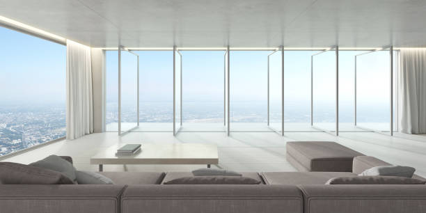 istock 3d render of large windows panel and terrace on city background, Modern living room with sofa and concrete floor. 1268234027