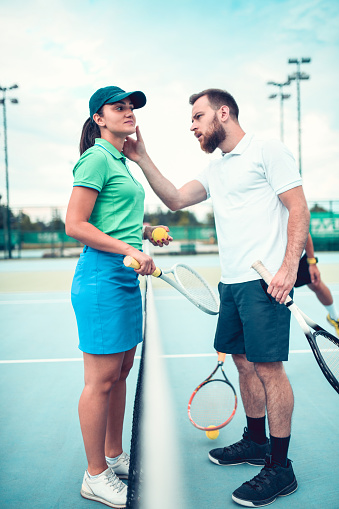 Male Examining Female Tennis Injury Before Match