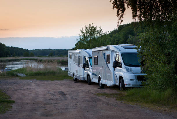 two recreational vehicles are parked in parking lot
