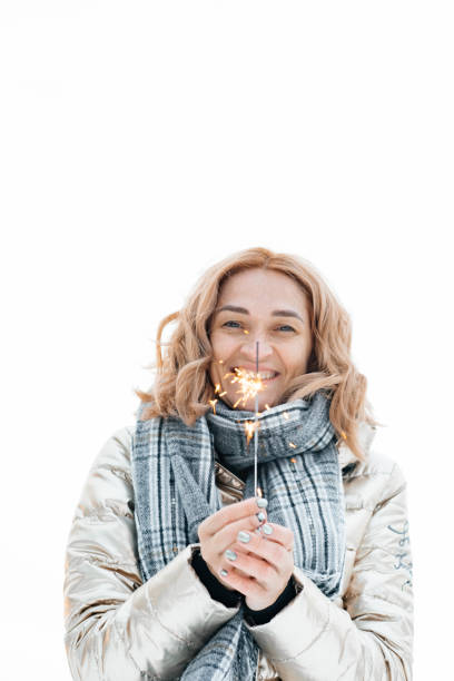 istock Girl in a white jacket on a white background with Bengal fire in her hands. 1268234692