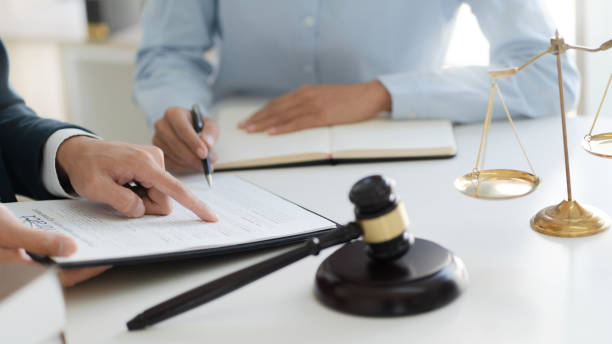 istock Lawyer consultant explaining to client with law suit. 1268237343