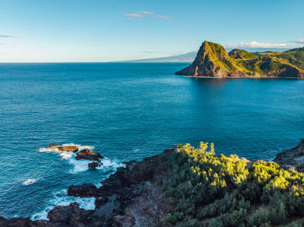 istock Marvelous shore. Large boulder among the waves in the sea. Hawaii 1268237816